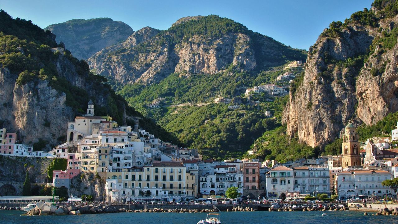 The town of Amalfi seen from the sea, with its cathedral bell tower and the mountains behind