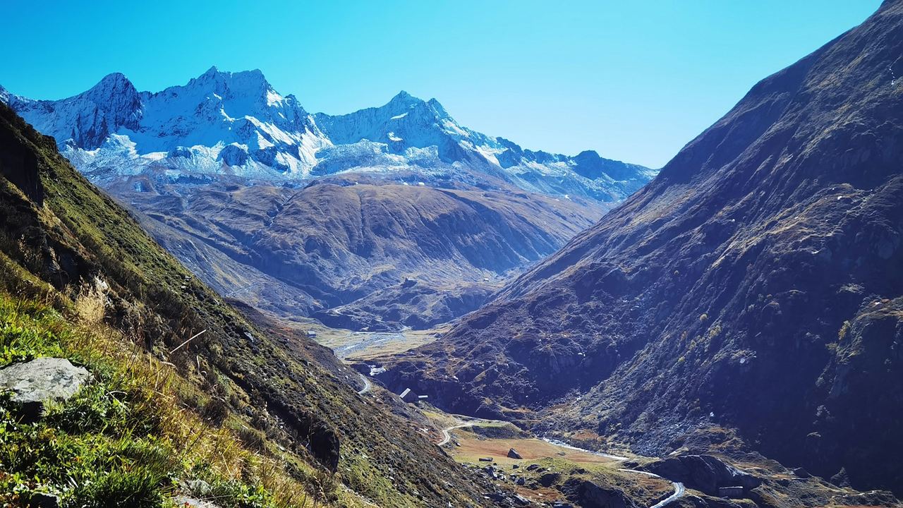 The Urseren valley at Andermatt below snow-topped mountains
