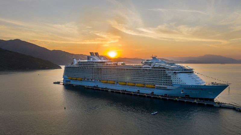 Symphony of the Seas at anchor at sunset