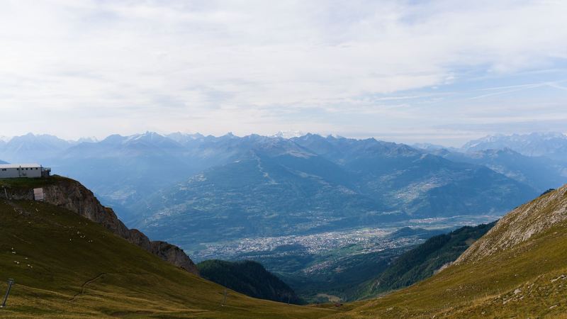 The Rhône valley and its towns seen from the summer pastures high above, with the peaks of the Valais beyond
