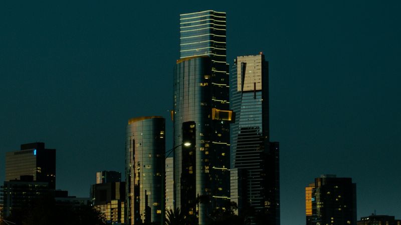Melbourne’s towers at dusk above the Albert Park grandstands