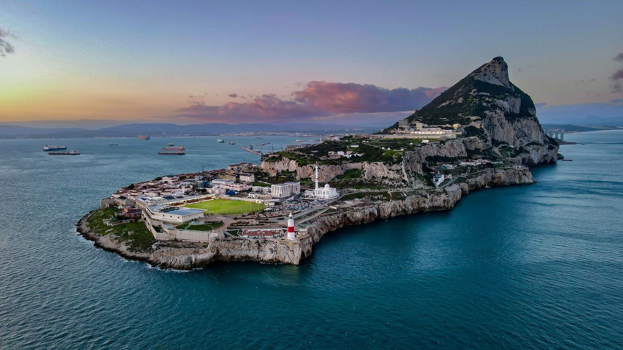 The Rock of Gibraltar and Europa Point with its lighthouse at sunset, seen from above the Strait