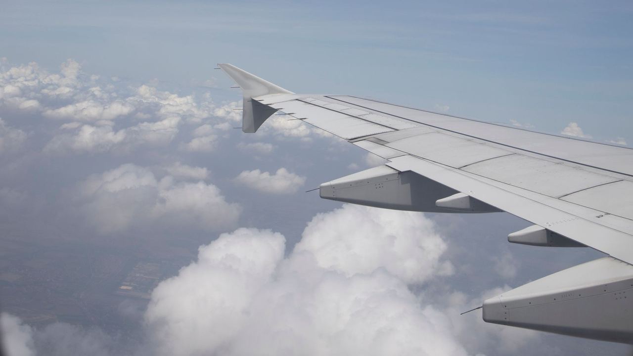 An aircraft wing above the clouds