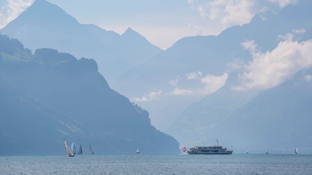A lake steamer and sailing boats on Lake Lucerne