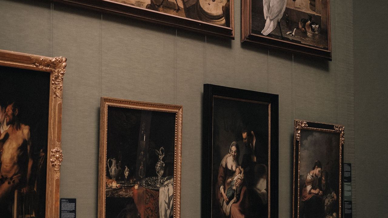 Old Master paintings in gilded frames on a gallery wall