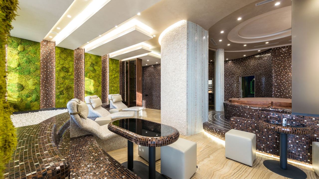 An indoor pool with a waterfall and marble