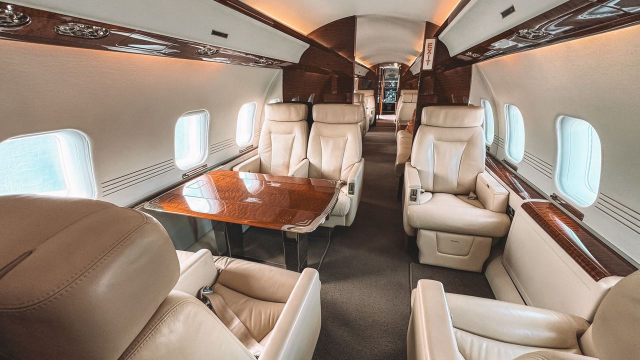 The cream leather cabin of a private jet