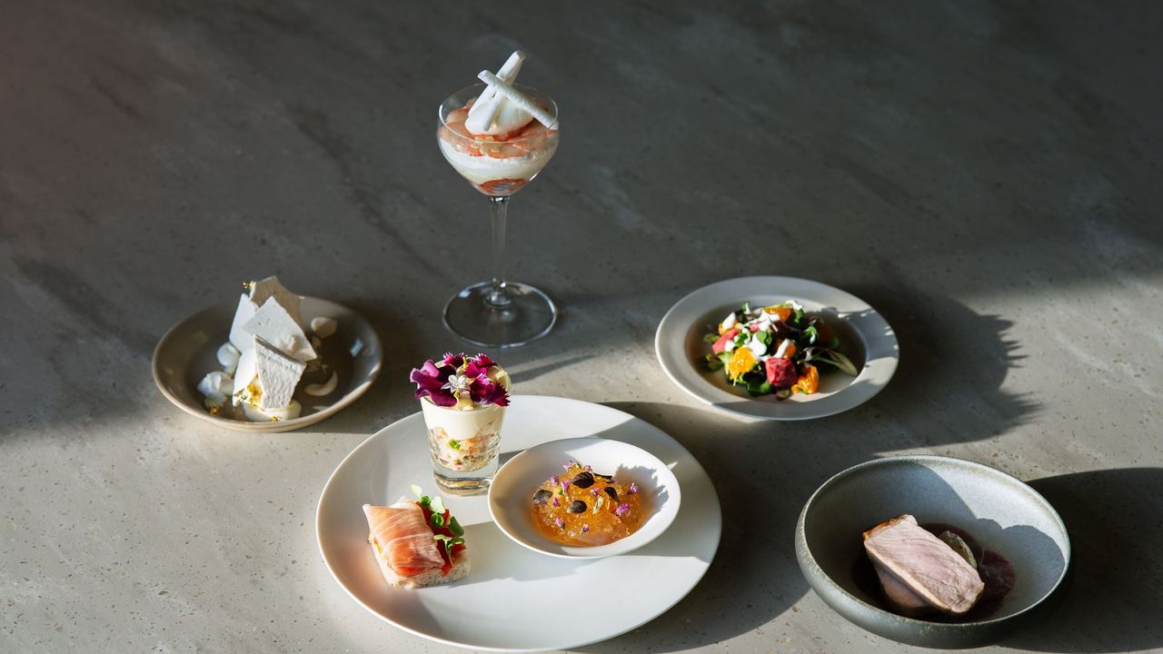 A tasting menu of small plates on a stone table