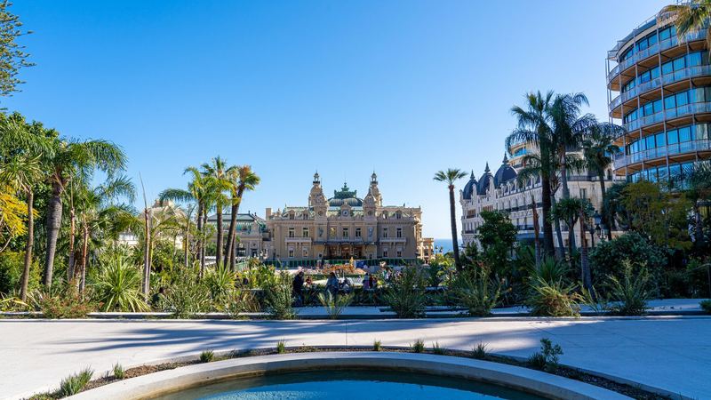 The Casino de Monte-Carlo beyond the palm gardens of the Place du Casino, with the Hôtel de Paris and One Monte-Carlo to the right