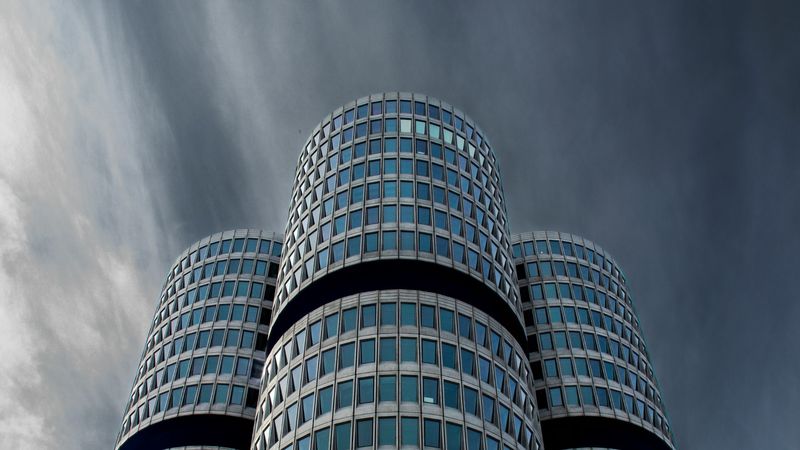 The four-cylinder tower of BMW’s headquarters in Munich under a stormy sky
