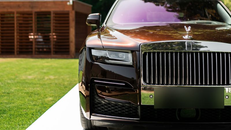 The Spirit of Ecstasy and the grille of a Rolls-Royce Ghost in a garden