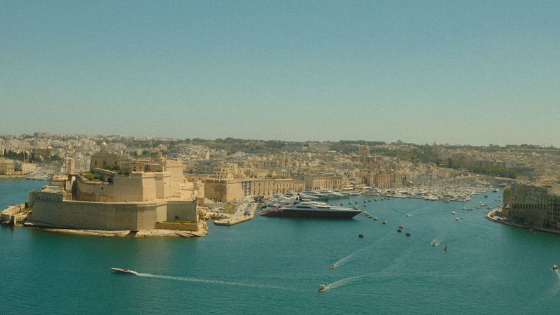 Birgu and its bastions on a creek of the Grand Harbour, yachts at anchor and Valletta beyond