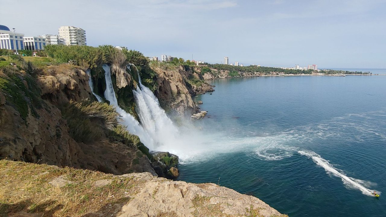 The Düden waterfall falling from the cliffs into the sea, the Antalya coast beyond