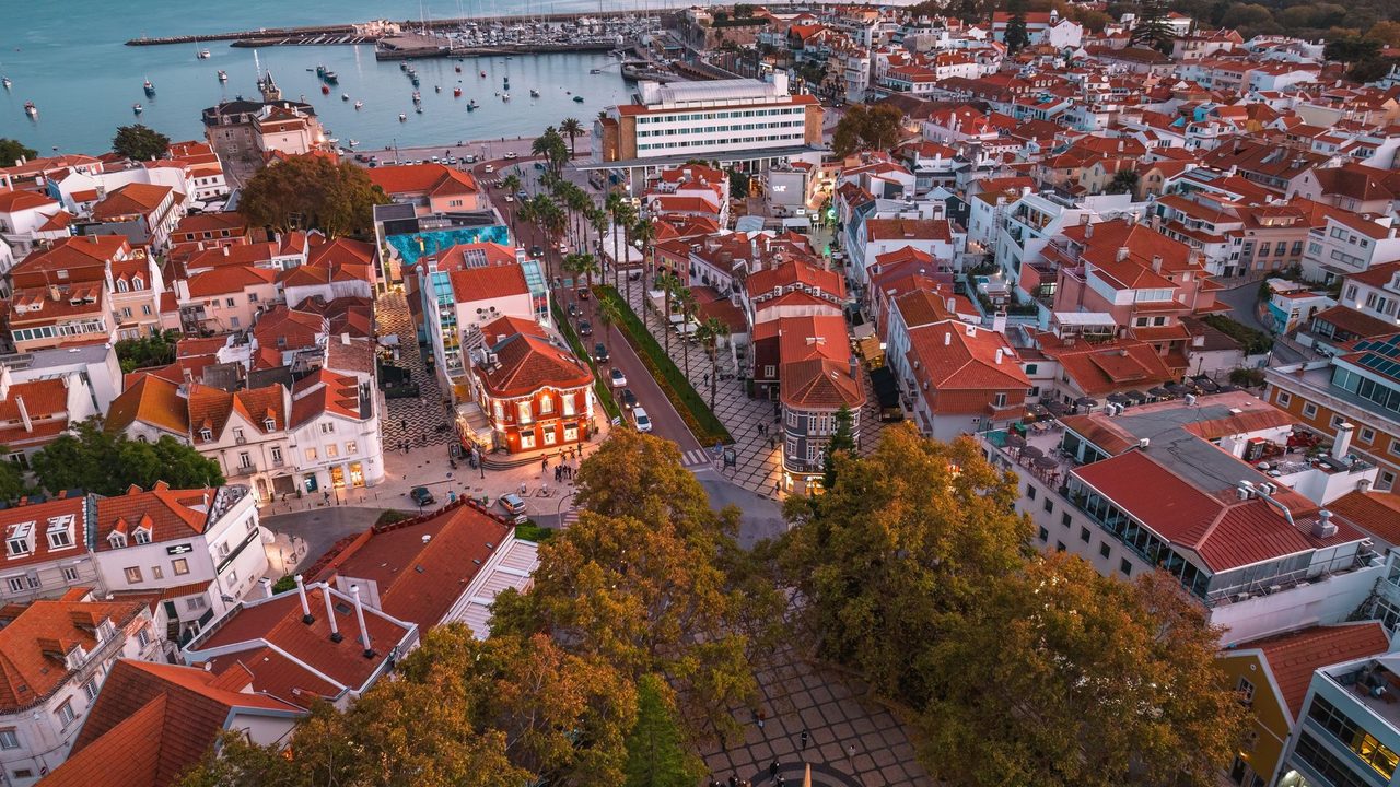 The red roofs of Cascais at dusk, the bay and marina beyond