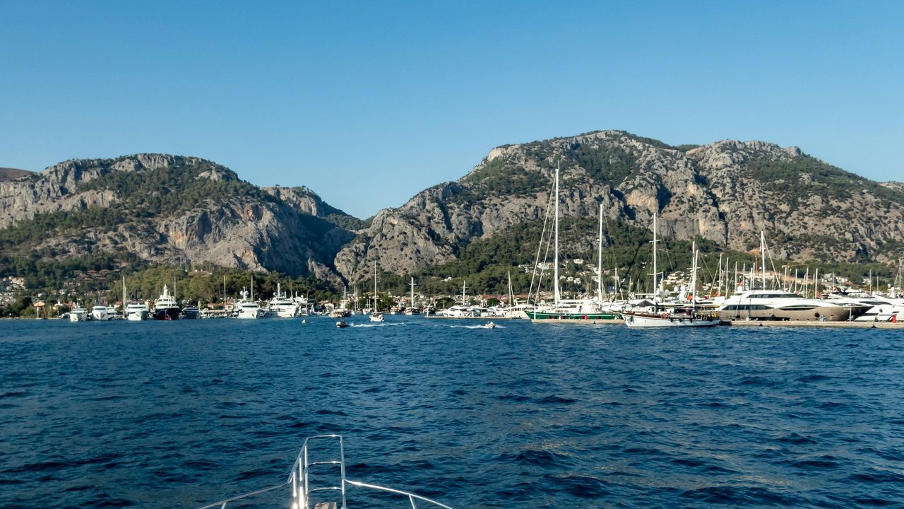 Superyachts and gulets in the bay of Göcek below the Taurus mountains, from the deck of a yacht