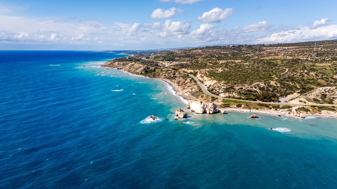 Aphrodite's Rock and the turquoise coast of Paphos from the air
