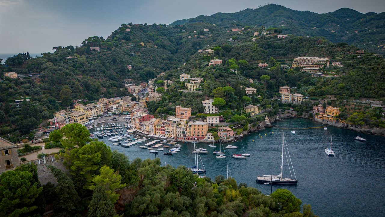 The harbour of Portofino, its painted houses and the hillside villas from above