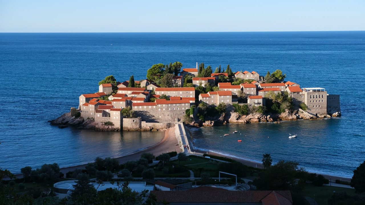 The island village of Sveti Stefan and its beaches in the evening sun, Montenegro
