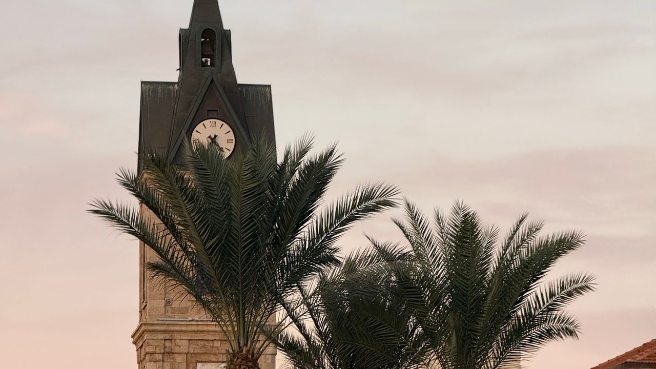 The Ottoman clock tower of Jaffa and its palms at dusk, Tel Aviv