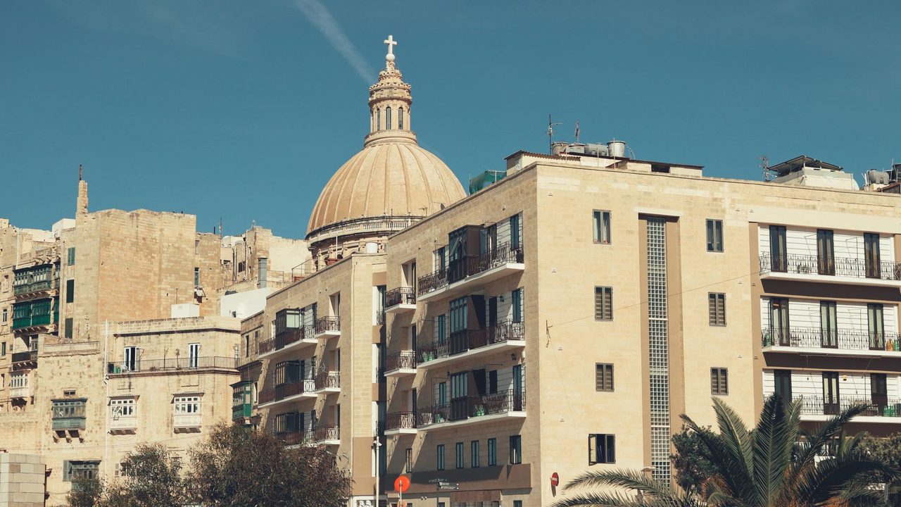 The dome of the Carmelite Basilica above the limestone houses and bastions of Valletta