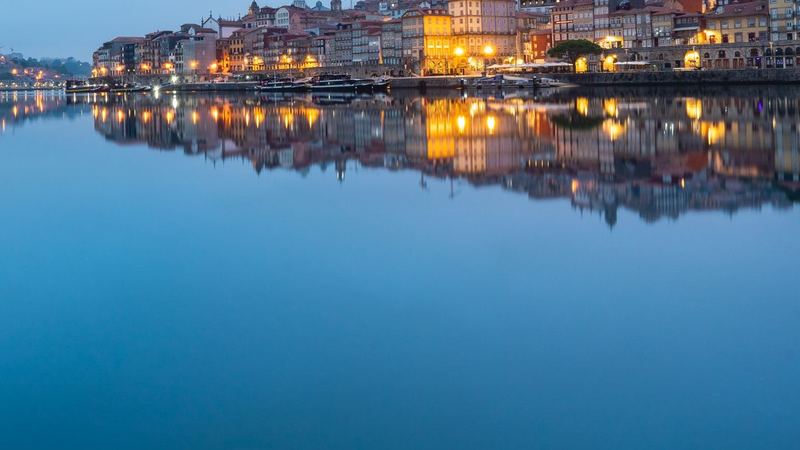 The lights of the Ribeira reflected in the still Douro at dawn