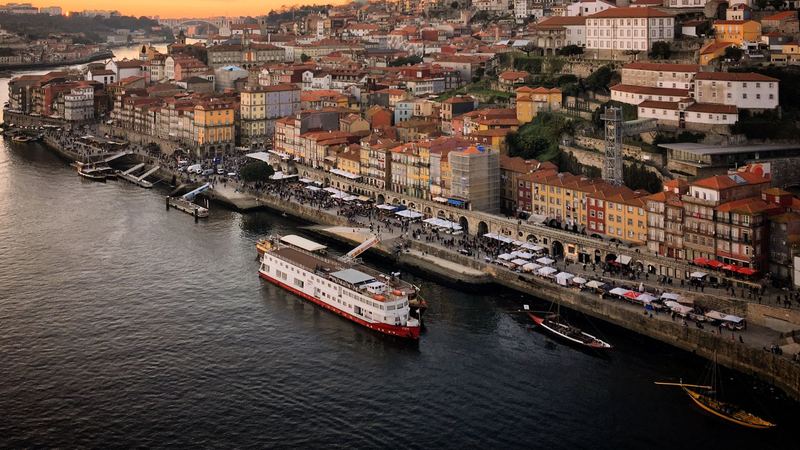 Porto at night, the Dom Luís I bridge lit above the Douro and the Ribeira